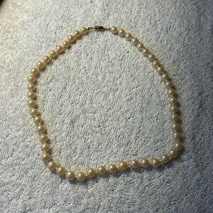 Faux champagne color pearl necklace hand knotted. Overall length 18”